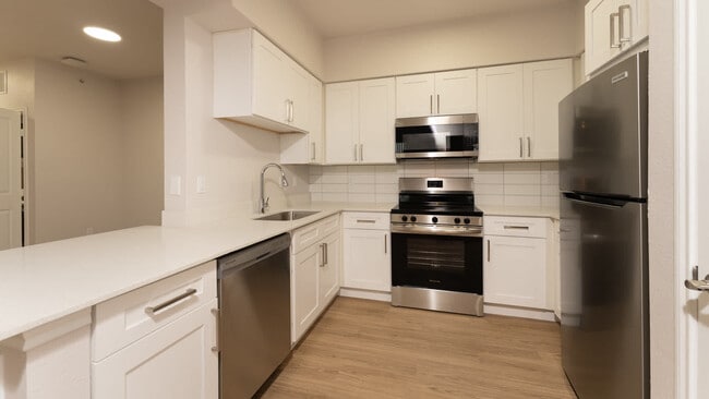 Kitchen with island and hard surface flooring - Kia Ora Park