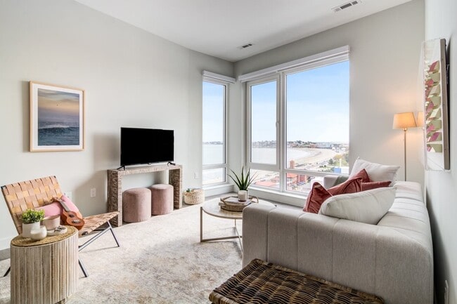 Large windows here put Revere Beach in front of you from the sofa.
