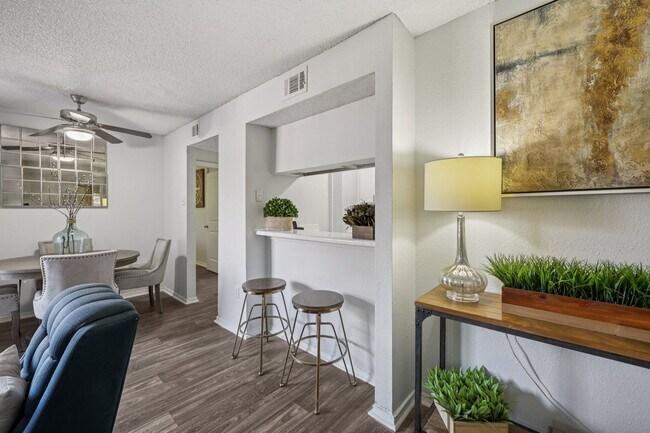 Open-concept living and breakfast bar seating at Creekside On The Green Apartments.