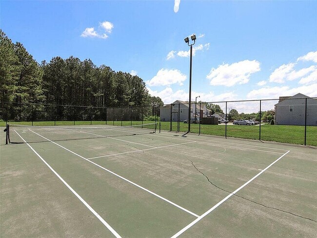 Enjoy a match in this well-maintained tennis court, perfect for sports enthusiasts.