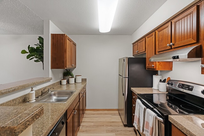 Experience the elegance of modern design with this kitchen's high-quality finishes and appliances. - 4425 Apartments