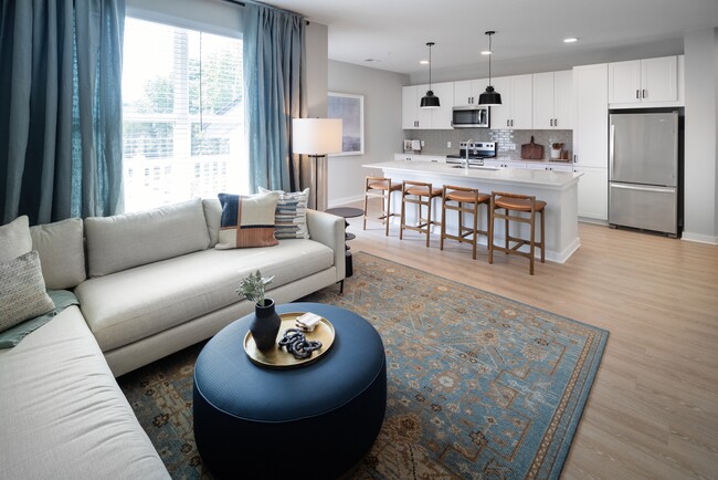 Kitchen, living, and dining area with hard-surface vinyl plank flooring