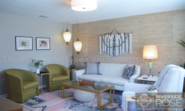 Living room with mid-century boho decor, local art, and high-end furnishings. - 3726 Moss Rose Dr Townhome