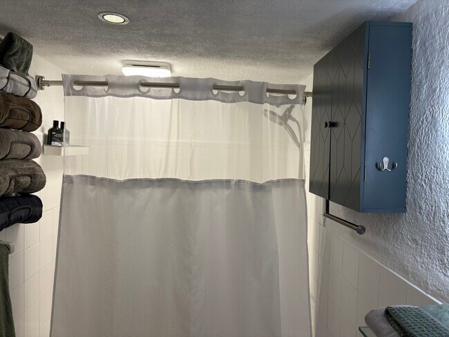 Bathroom with a tub and shower