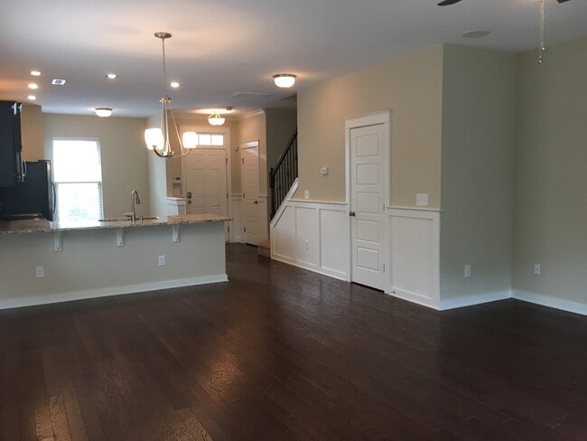 View of living room with dining area, half bath downstairs - 6417 Swatner Drive