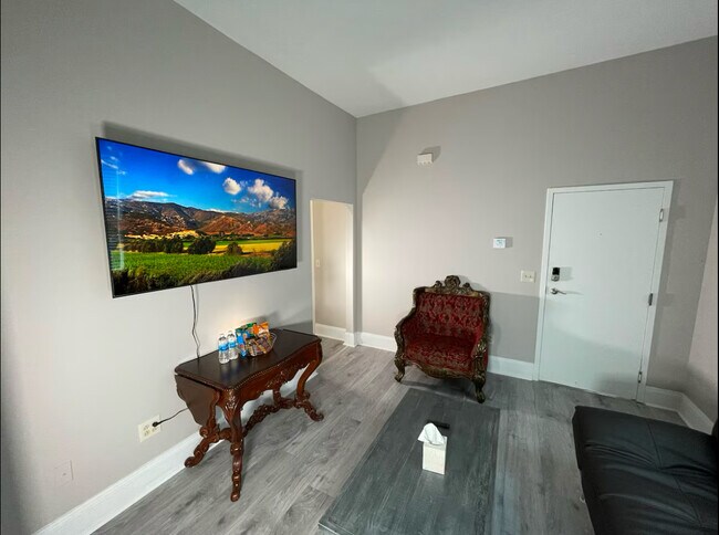 Living room pfuetrueisng a 65 in 4k smart Tv - 9201 Lorain Ave