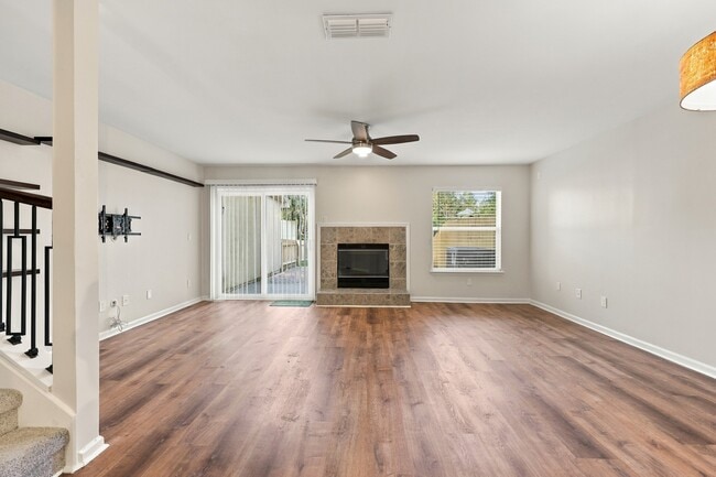 Spacious living room featuring a fireplace and direct access to the private backyard.