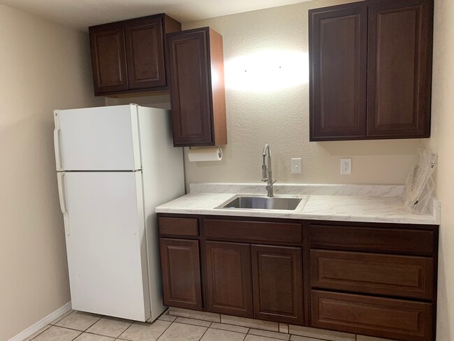 Kitchen with refrigerator - 636 Commercial Ave Unit A