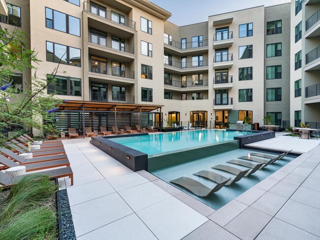 Relax in style at Modera Trailhead’s resort-inspired pool, featuring in-water loungers and ample deck seating for sun-soaked days in Dallas.