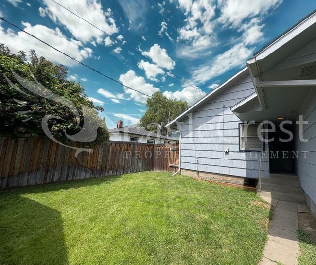 Photo - Three Bedroom, Two Bathroom House with Fenced Yard and Outdoor Fireplace