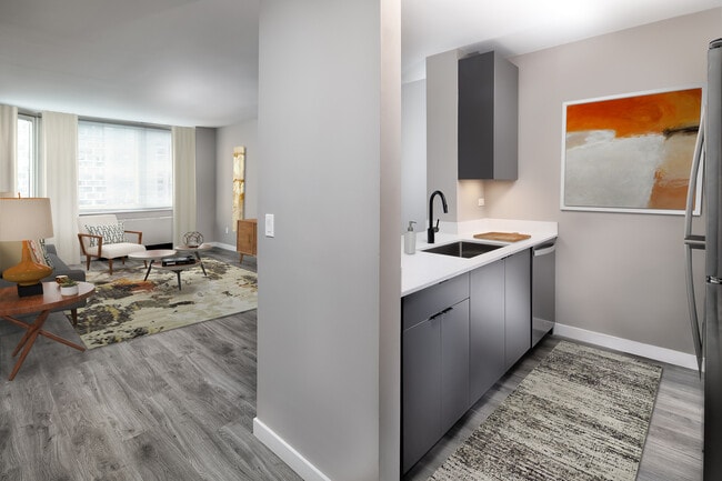 Renovated Package II kitchen, living, and dining areas with hard surface plank flooring
