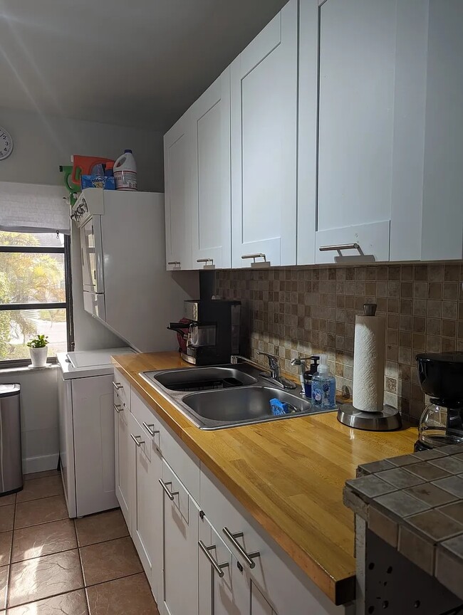 Stainless steel double sink includes garbage disposal.