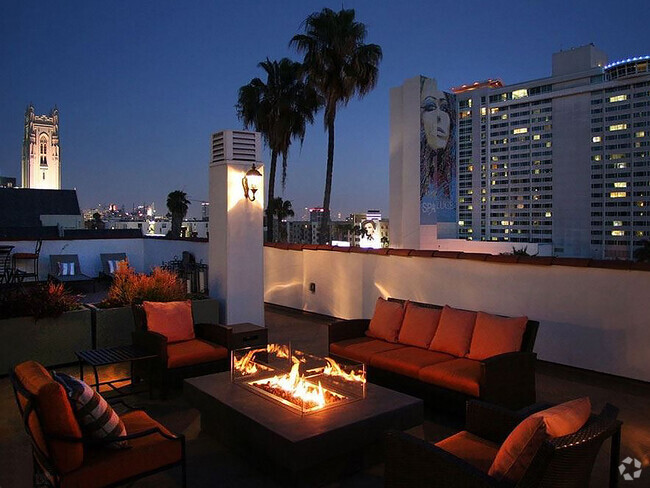 Beautiful nighttime view of rooftop patio with gas firepit and view of Franklin below. - Bonita Terrace Rental