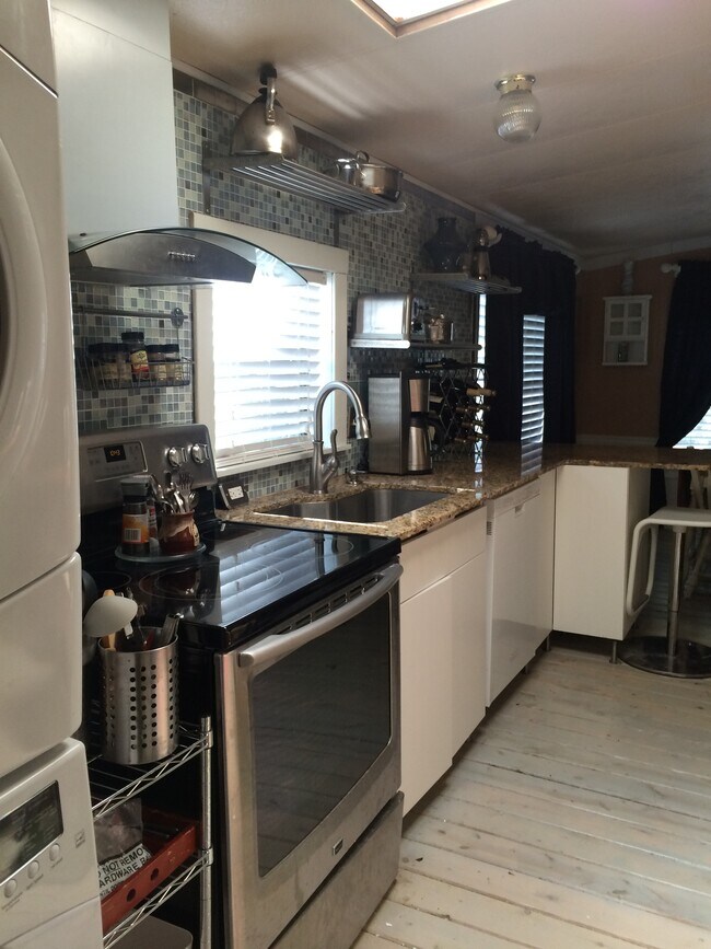 Kitchen open plan with plenty of prep and cook space. Island seating.