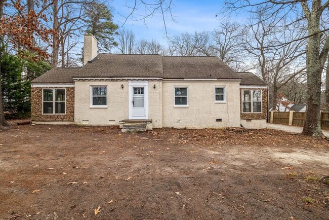 Building Photo - Brick home, Two Story, Hardwoods, DR, 2 Sun Rooms, FP, Carport!.