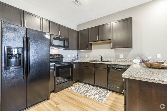 Our large kitchens feature granite countertops, modern hardware and ample storage. - The Flats at 84 Rental