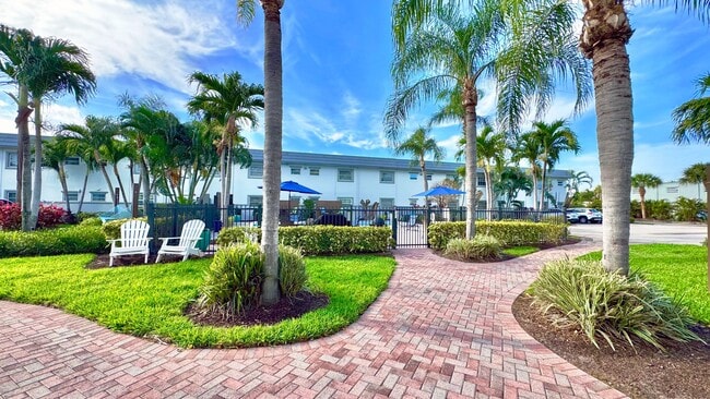 Enjoy a scenic stroll through lush tropical landscaping leading to the serene pool area.