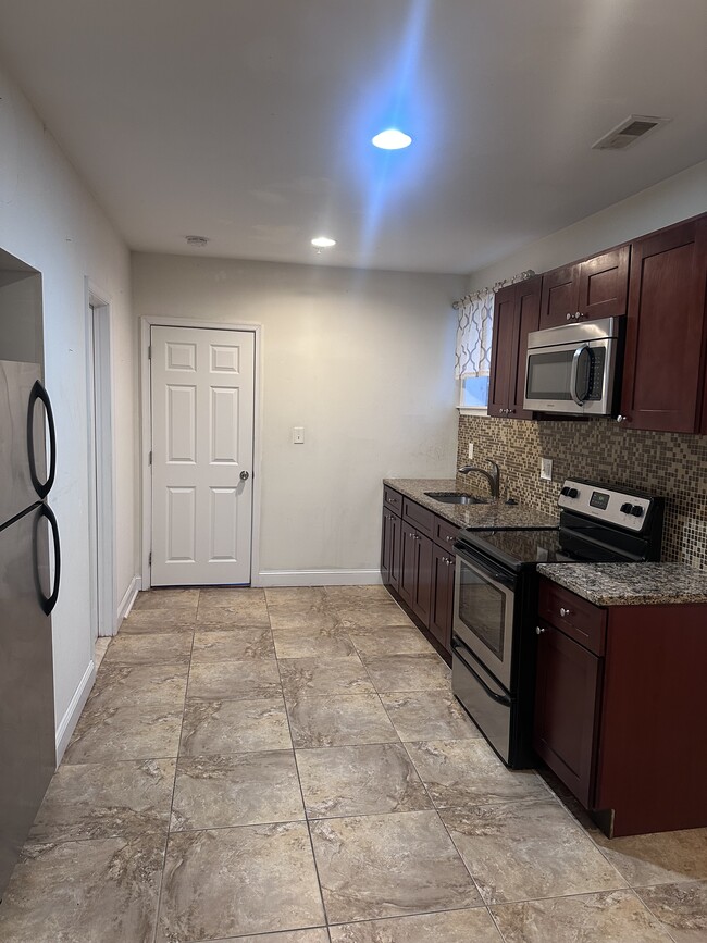 Kitchen and living area. - 2007 W Oxford St Apartments Unit 1B