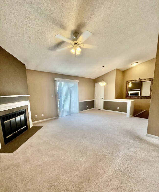 Living/dining room with vaulted ceilings, fireplace and sliding glass doors to front deck - 1458 High School Dr Condo Unit 1458 High School Drive