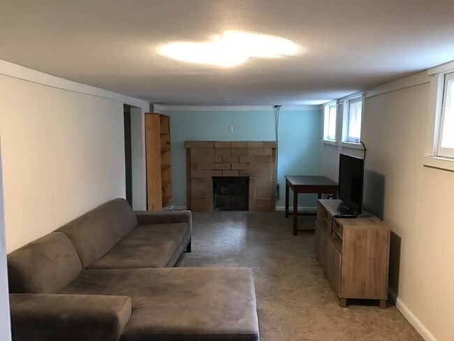 Downstairs living area - new carpet, sofa included in rental! - 3909 Perry Street
