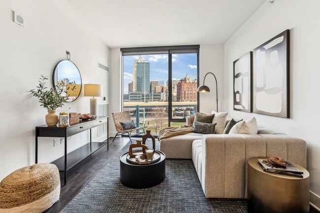 Modern city comfort — a sunlit living room where sleek design meets serene views. - 333 Water