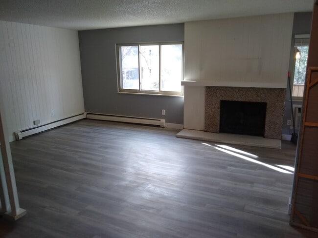 living room with wood fireplace - 3315 Chisholm Trail Unit 204