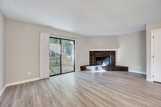 The large living room with a wooded view - 4115 Arckelton Dr
