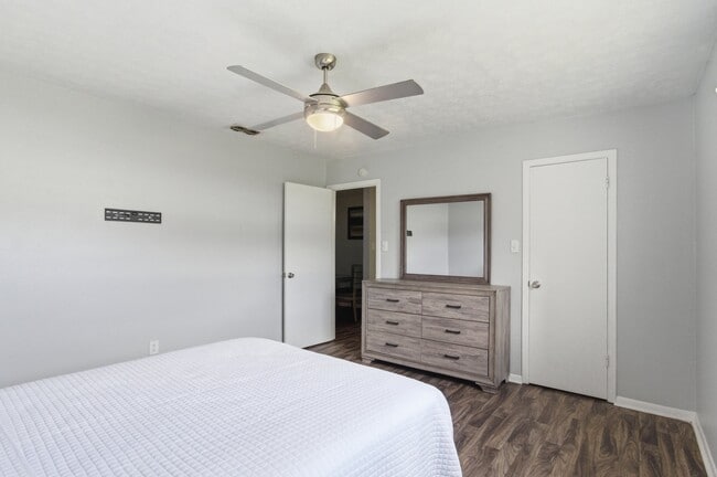 Relax in a well-appointed bedroom at Aspen Run Apartments in Tallahassee, complete with a ceiling fan for year-round comfort.