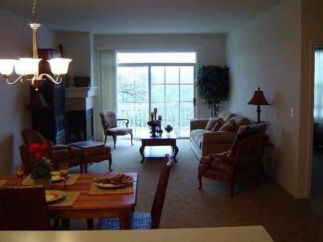 large family room with walk out balcony featuring views of the fox river and a gas fireplace
