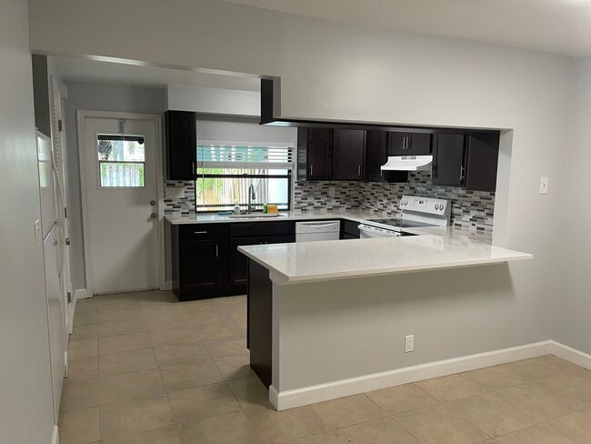 Renovated kitchen with bar seating - 2051 Cove Ln