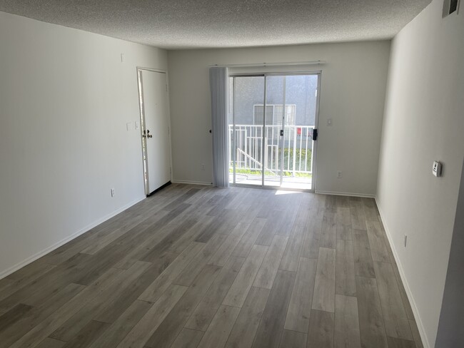 Living room with New Luxury Vinyl plank flooring - 18071 Beneda Ln Apartments Unit 114