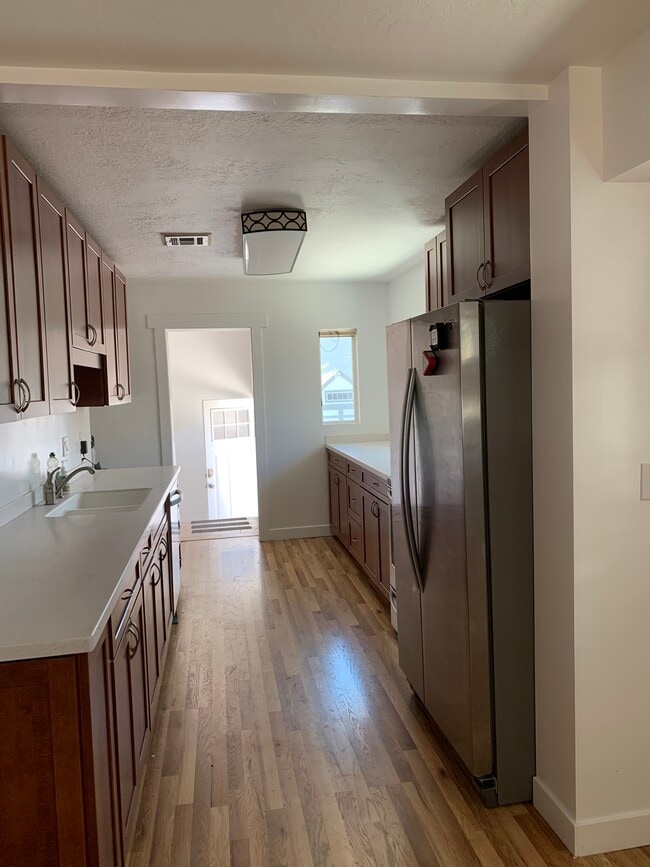 Long kitchen with lots of cabinets and counter space. Stainless steel appliances! - 544 Wilmington Ave