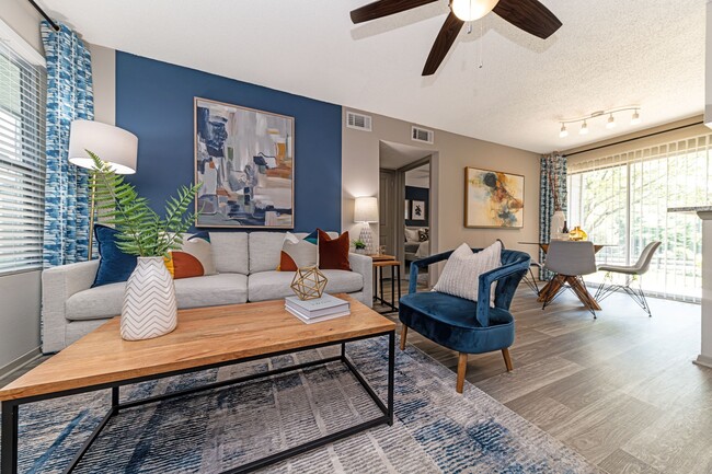 Living room and dining area with hardwood-style flooring - Veridian Lexington