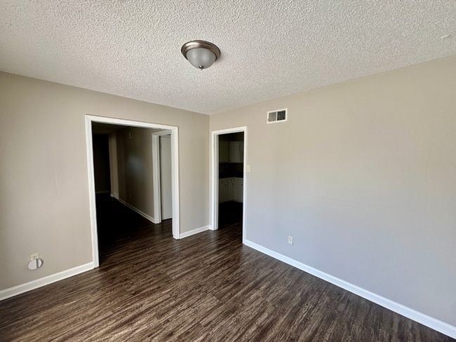 Photo - Charming 3BR/2BA Near Southwind | Soaring Vaulted Ceilings, Brick Fireplace & Fenced Yard