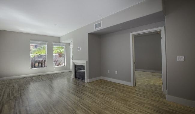 Spacious living room features a fireplace and access to private patio