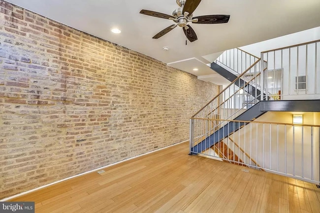 Large living room with floating stairs - 122 N Bradford St