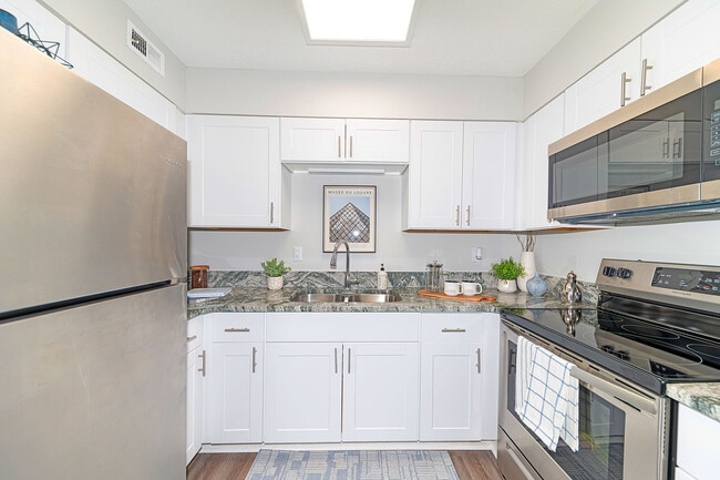 Kitchen with granite counters, stainless appliances, and modern cabinetry - Vetra Lexington