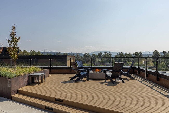Perch rooftop deck with a lit fire pit