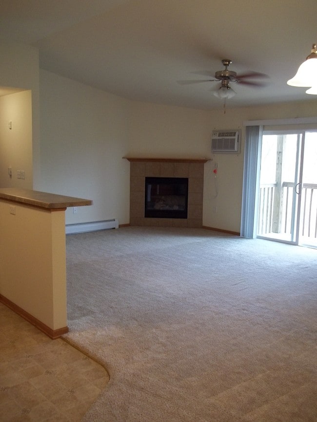 Spacious living room with warm inviting gas fireplace.