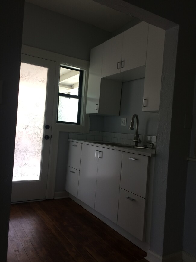 View of the East side of the kitchen. The glass door you see on the left leads to the carport. - 1819 North Laurel Avenue Townhome