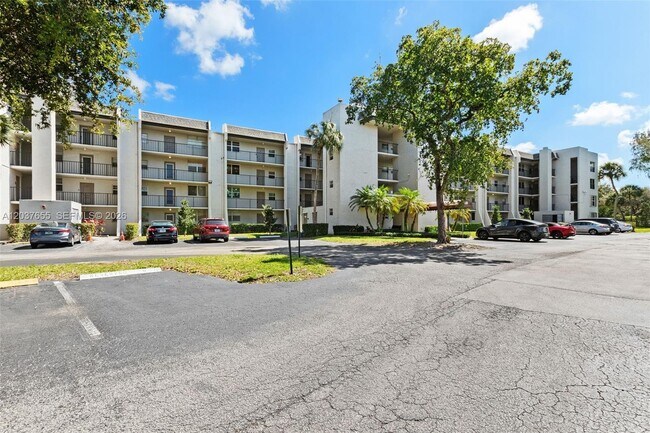 Building Photo - 9480 Poinciana Pl Unit 407