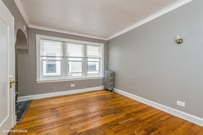 Beautifully refinished wood floors flow seamlessly throughout the home. - 3935 W Diversey