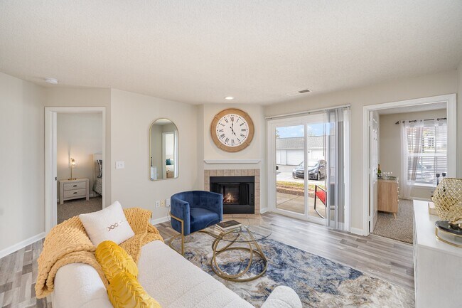 Living Room with Fireplace and Woodgrain Flooring