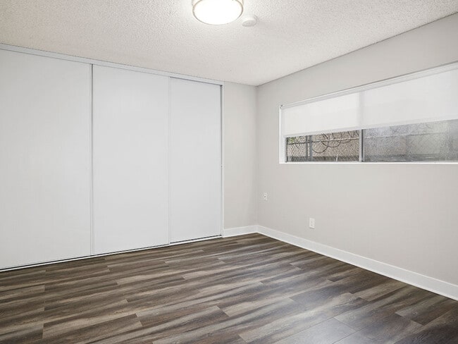 Hardwood floored bedroom with private closet.