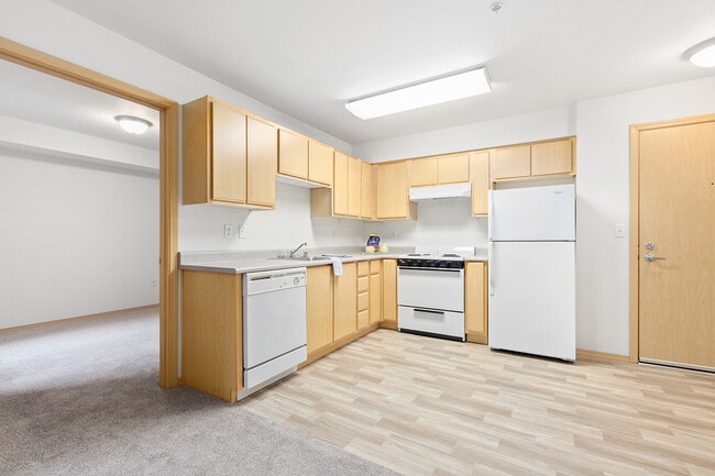 Open kitchen and bedroom - New Haven Senior Living Apartments