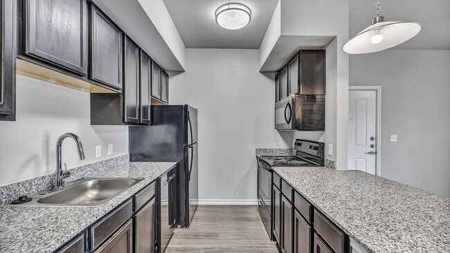 Enjoy granite countertops, stainless steel farm sinks, and black appliances