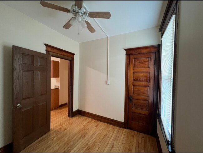 Number one bedroom with a closet and ceiling fan - 3748 W Lyndale St Unit 1st