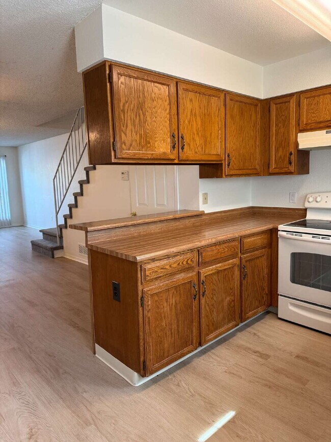 Photo - Cozy 2 Bed, 1.5 Bath Townhouse with Fireplace + Community Pool + Reserved Parking Space! Unit A