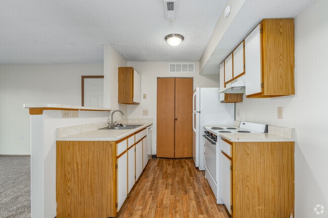 Kitchen of a River Valley apartment home in Lancaster, OH, with cabinets, stove, oven, refrigerator.