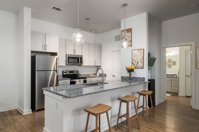 Spacious Kitchen with Granite Countertops - Leo Loso Apartments